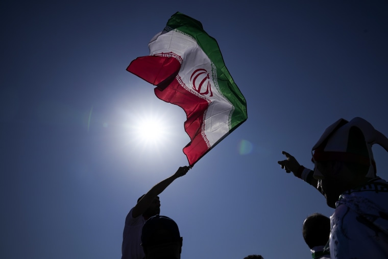 A supporter waves an Iranian flag ahead of the World Cup match between Wales and Iran in Al Rayyan, Qatar, on Nov. 25, 2022.