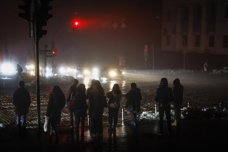 Residents walk through an unlit street in Kyiv, Ukraine, on Nov. 24, 2022.