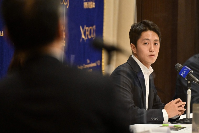 Japanese documentary maker and journalist Toru Kubota (R), who was recently released from Myanmar in a prisoner amnesty, listens to a question during a press conference at the Foreign Correspondents' Club of Japan in Tokyo on November 28, 2022. - Kubota spent three and a half months in prison after being detained near an anti-government rally in Yangon in July along with two Myanmar citizens.