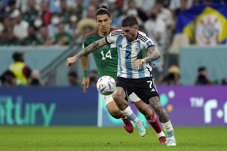 Erick Gutierrez and Rodrigo De Paul uring the World Cup group C soccer match between Argentina and Mexico