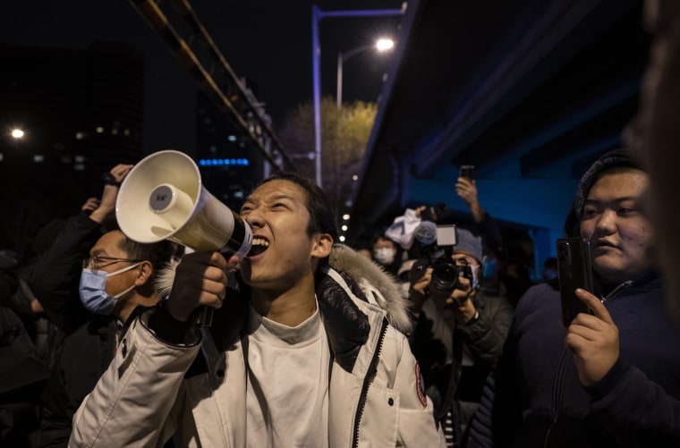 A protesters shouts slogans during a protest against Chinas strict zero COVID measures in Beijing, China.