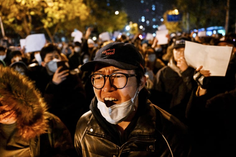 Protesters march for the victims o a deadly fire and rally against China's harsh Covid-19 restrictions in Beijing on Nov. 28, 2022.
