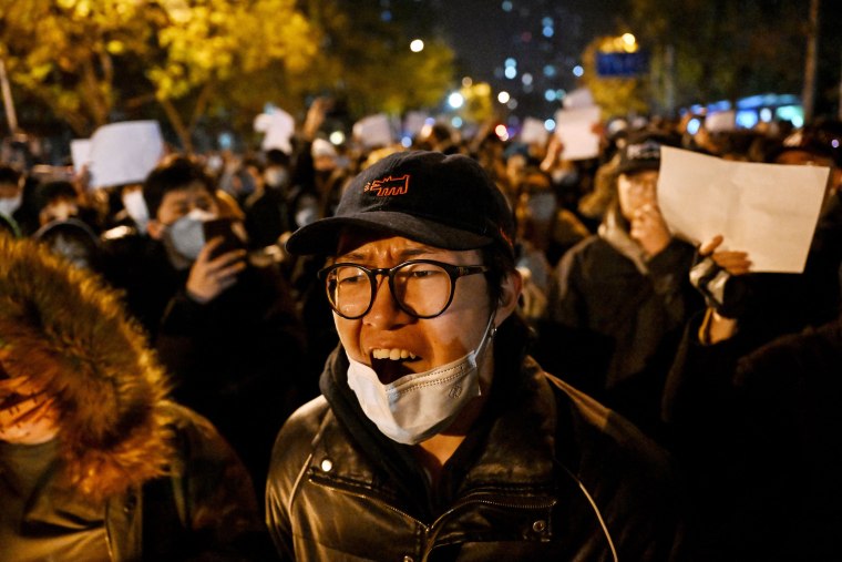 Protesters rally against China's harsh Covid restrictions in Beijing on Monday.
