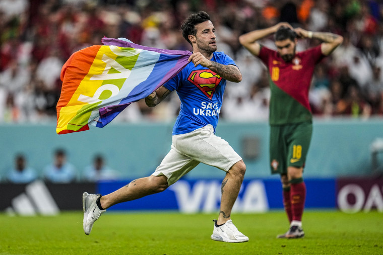 Image: A pitch invader runs across the field with a rainbow flag during the World Cup group H soccer match between Portugal and Uruguay, at the Lusail Stadium in Lusail, Qatar, on Nov. 28, 2022. 
