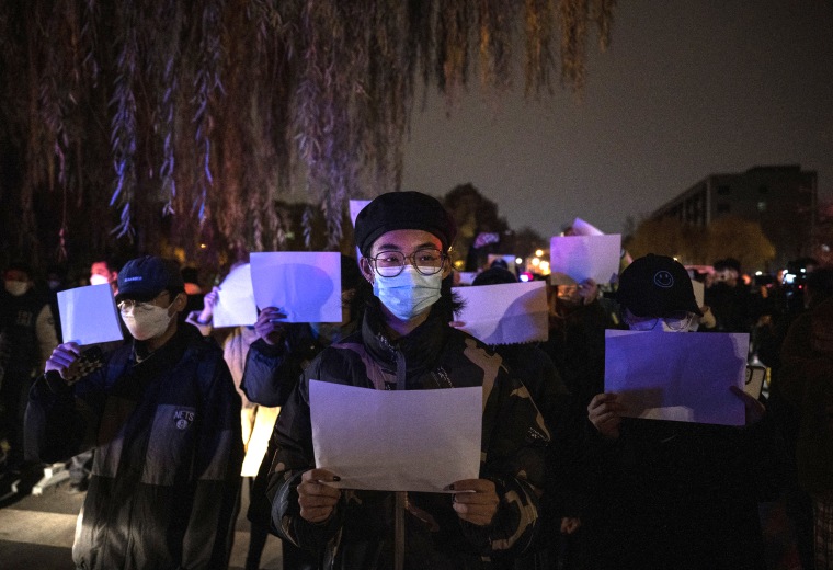 Demonstrators hold up white pieces of paper against censorship during a protest against China's strict zero-COVID measures in Beijing.