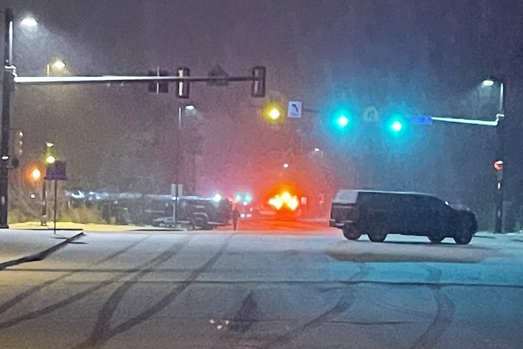 Police vehicles near the scene where authorities say an armed man barricaded himself inside a home in Boulder, Colo., on Tuesday.