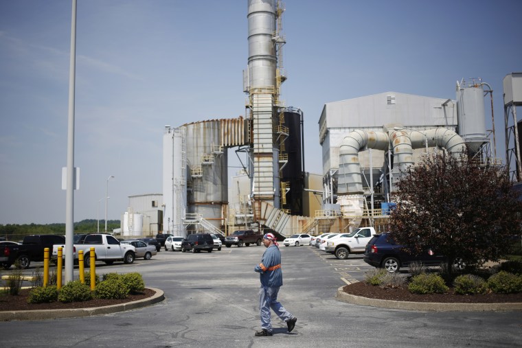 A plant employee walks through the parking lot at Century Aluminum Company's smelter
