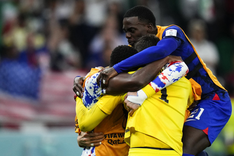 Tim Weah of the United States, right, celebrates with teammates after winning their World Cup match against Iran in Doha on Nov. 30, 2022.