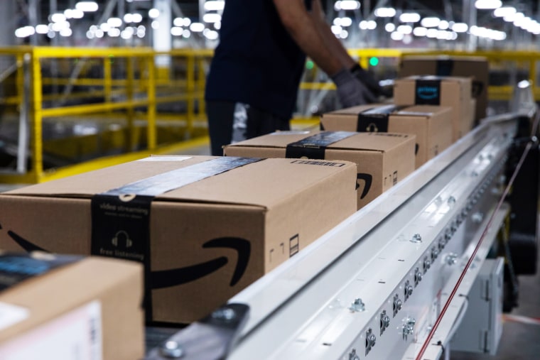 Boxes move along a conveyor belt at an Amazon fulfillment center on Prime Day in Raleigh, N.C.