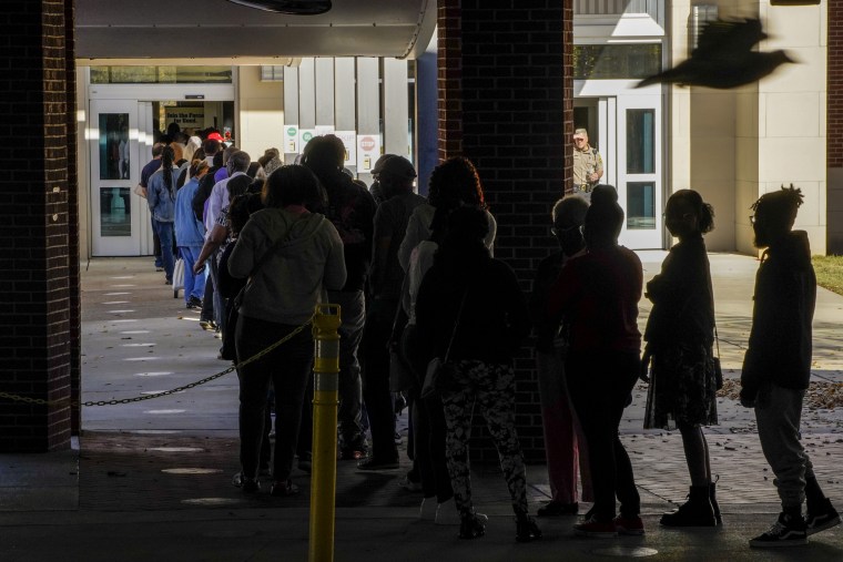 Voters wait in line in Columbus, Ga., on Nov. 27, 2022.