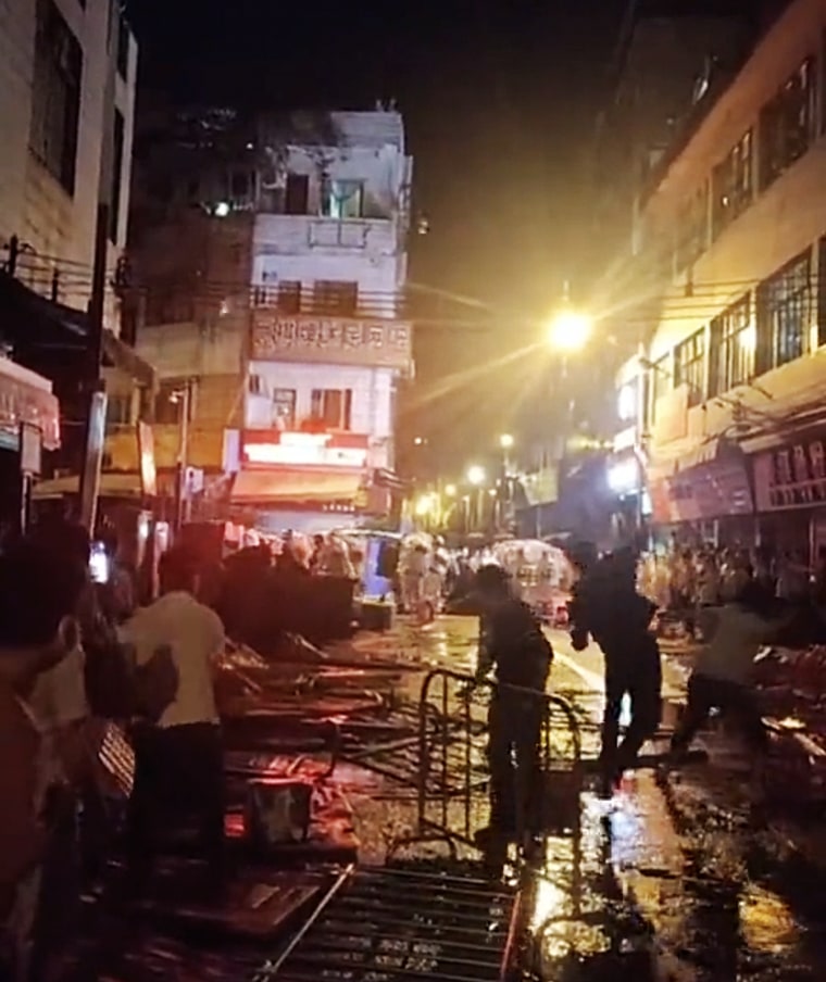 People throw objects at police officers in Guangzhou.