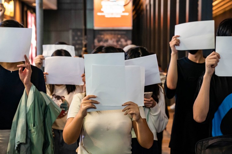 People hold sheets of blank paper in protest of Covid-19 restrictions on mainland China on Nov. 28, 2022, in Hong Kong.