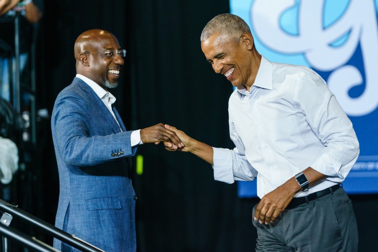Barack Obama greets Raphael Warnock, left, as he arrives at a campaign event for Georgia Democrats in College Park, Georgia.