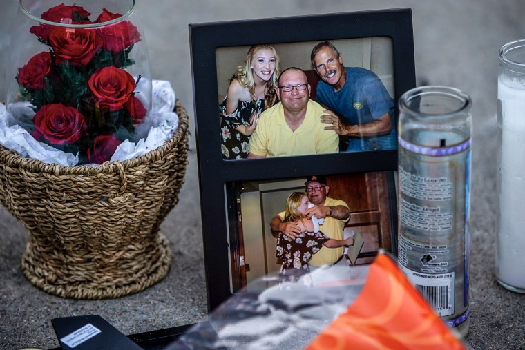 Family photographs forming part of a memorial in the driveway of the home where three family members were murdered, November 29, 2022 in Riverside, California.