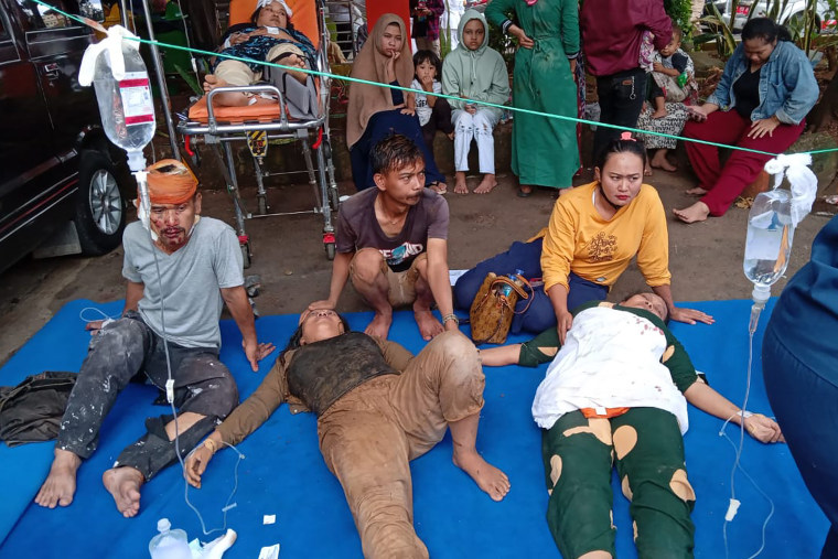 People injured during in the earthquake in Indonesia are treated in a hospital parking lot in Cianjur, West Java