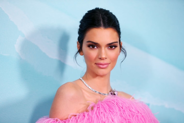Kendall Jenner on the red carpet in a pink dress.