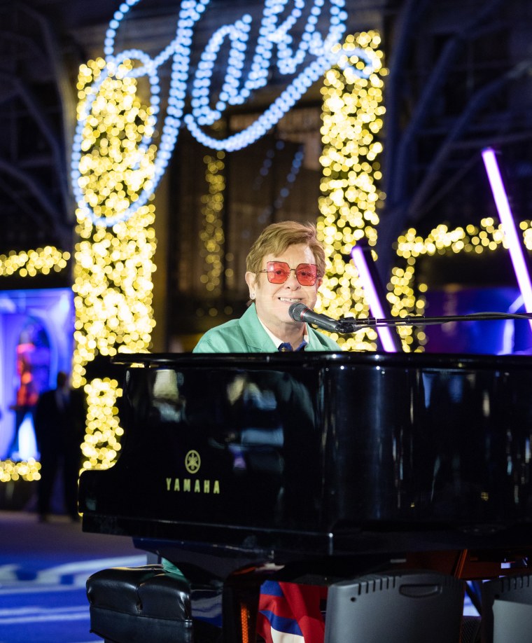 Elton John performs at the Saks Annual Holiday Window Unveiling at its New York Flagship store.