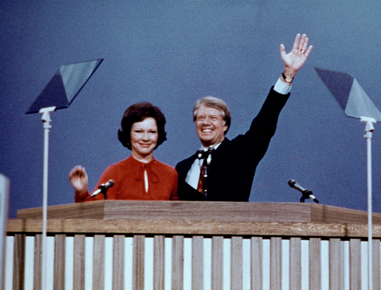 Governor Jimmy Carter, the 1976 Democratic Party nominee for President of the United States, right, and his wife Rosalynn Carter, left, acknowledge the cheers of the delegates following their acceptance speeches at the 1976 Democratic Convention.