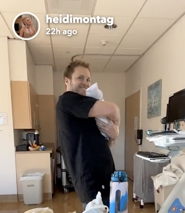 Spencer Pratt holds his newborn at the hospital.
