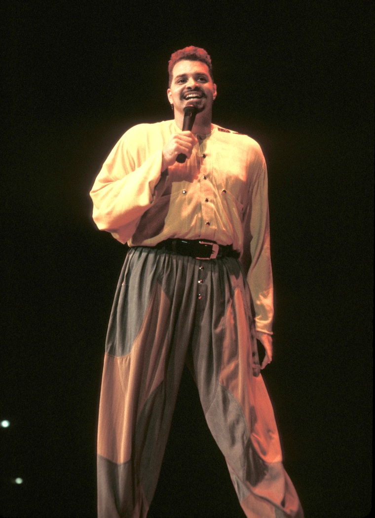Stand up comedian and actor David Adkins, better known by his stage name Sinbad, is shown performing on stage during a live concert appearance.