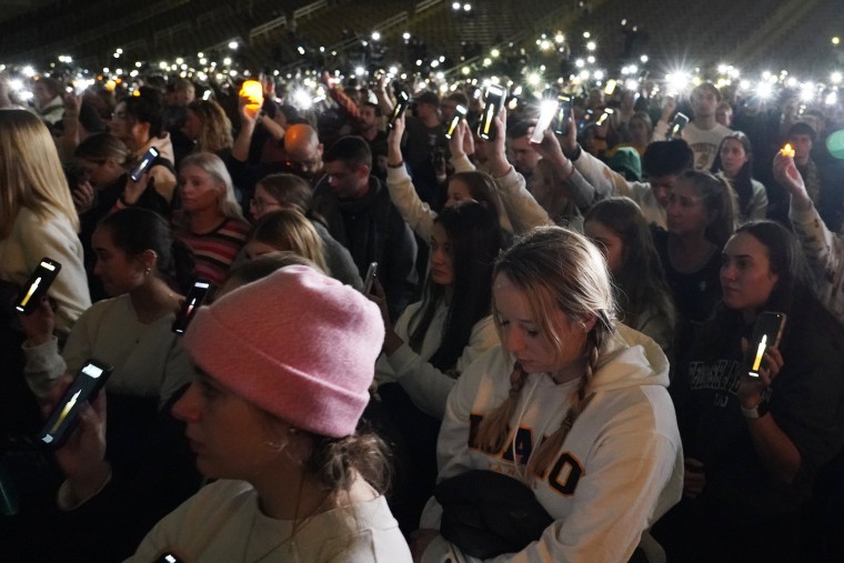 People attending a vigil for the four University of Idaho students who were killed on Nov. 13, 2022, hold up their phones during a moment of silence, Wednesday, Nov. 30, 2022, in Moscow, Idaho.