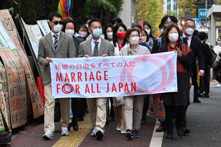 Plaintiffs and their supporters head to the Tokyo District Court in Tokyo on November 30, 2022, in a lawsuit filed by same-sex couples seeking damages from the government arguing the ban on same-sex marriage is unconstitutional.