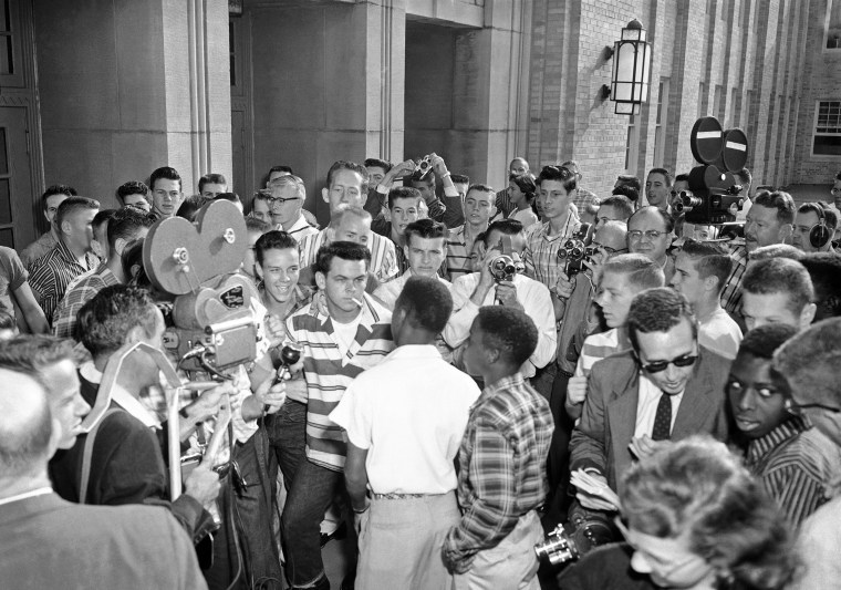 Defiant white students at Arkansas' North Little Rock High School block the doors of the school, denying access to six Black students enrolled in the school, on Sept. 9, 1957. 