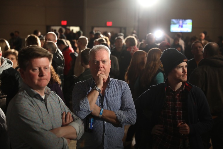Supporters of former U.S. Vice President Joe Biden, 2020 Democratic presidential candidate, wait for results during a caucus night watch party in Des Moines, Iowa, U.S. on Monday, Feb. 3, 2020. Iowa Democrats prepared to pack firehouses, schools and community centers across the state Monday night to give the first read in the race to challenge President Donald Trump in November.
