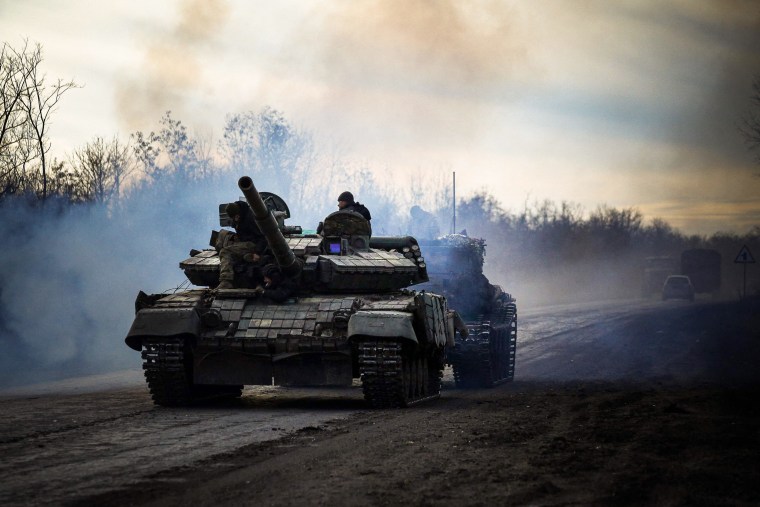 Ukrainian tank rolls along a road in Bakhmut, in the country's east. 