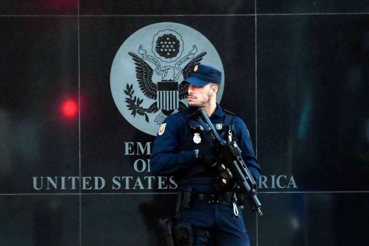A Spanish policeman stands guard near the U.S. embassy in Madrid, on Dec. 1, 2022, after they received a letter bomb.