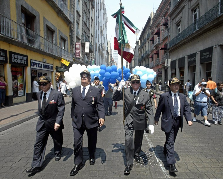 Former members of Mexican Air Force 201 squadron march in a parade