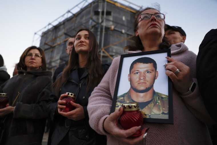 Family members of soldiers attend a memorial event in Kyiv