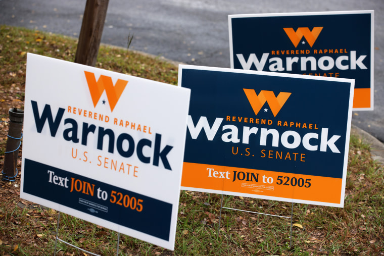 Campaign signs for Sen. Raphael Warnock