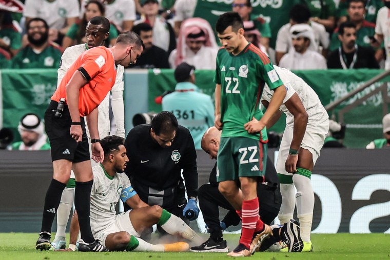 Image: Saudi Arabia's midfielder #10 Salem Al-Dawsari receives medical treatment during the Qatar 2022 World Cup