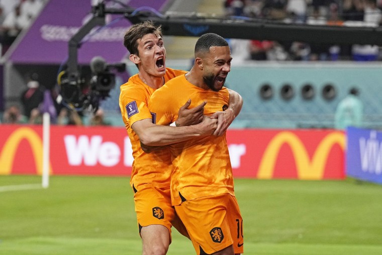 Memphis Depay of the Netherlands, right, celebrates after scoring the opening goal