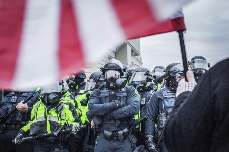 Riot police form heavy lines near the Capitol on Jan. 6, 2021 in Washington.