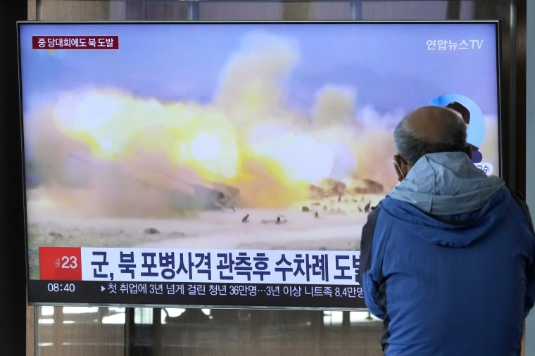 FILE - A TV screen shows a file image of North Korea's military exercise during a news program at the Seoul Railway Station in Seoul, South Korea, Wednesday, Oct. 19, 2022. South Korea’s military says North Korea has fired around 130 suspected artillery rounds Monday, Dec. 5, 2022, in waters near the rivals’ western and eastern sea borders in another display of belligerence. (AP Photo/Ahn Young-joon, File)