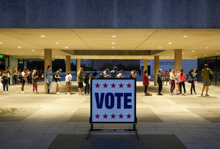 Voters wait in line at a polling place at the Lyndon B. Johnson School of Public Affairs in Austin, Texas