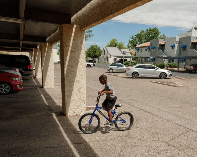Smith’s son rides a bike at their apartment complex. 