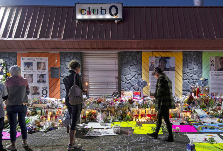 Mourners gather at a memorial for the victims of a mass shooting at Club Q