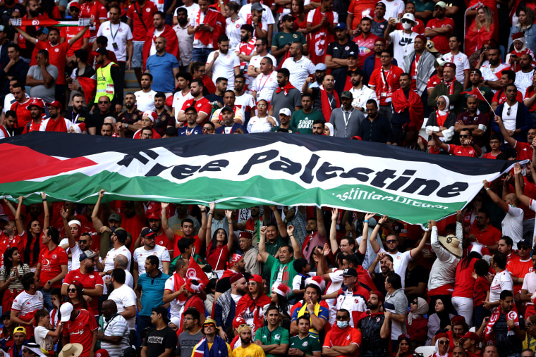 Image: Fans hold a "Free Palestine" banner at a World Cup match between Tunisia and Australia in Al Wakrah, Qatar, on Nov. 26, 2022.