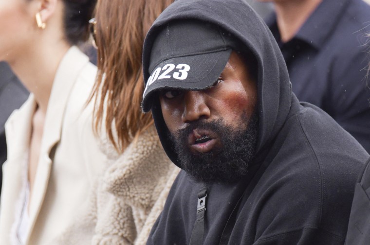 Ye watches the Givenchy show during Paris Fashion Week