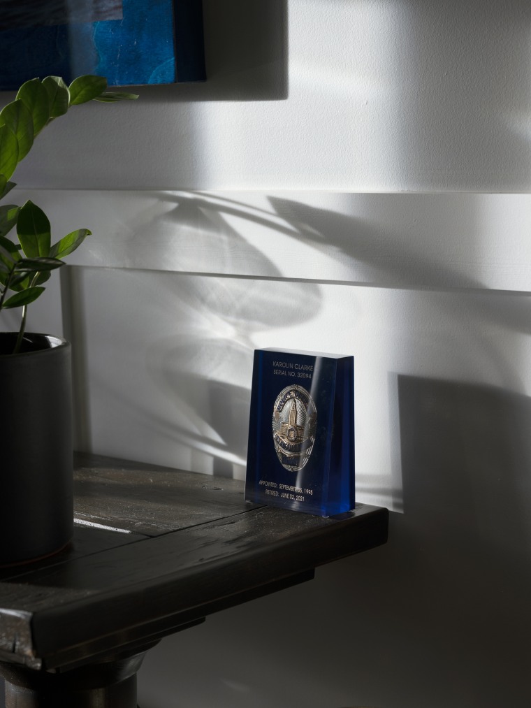 Karolin Clarke keeps her encased LAPD badge on a desk in her home.