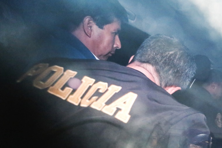 Castillo is escorted by police in Lima on Wednesday. 