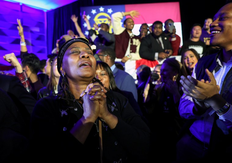Supporters cheer as the Georgia Senate runoff election is called for Sen. Raphael Warnock at an election right watch party in Atlanta.