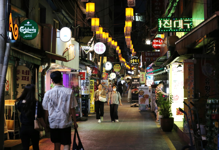 People walk down a street in Seoul, South Korea