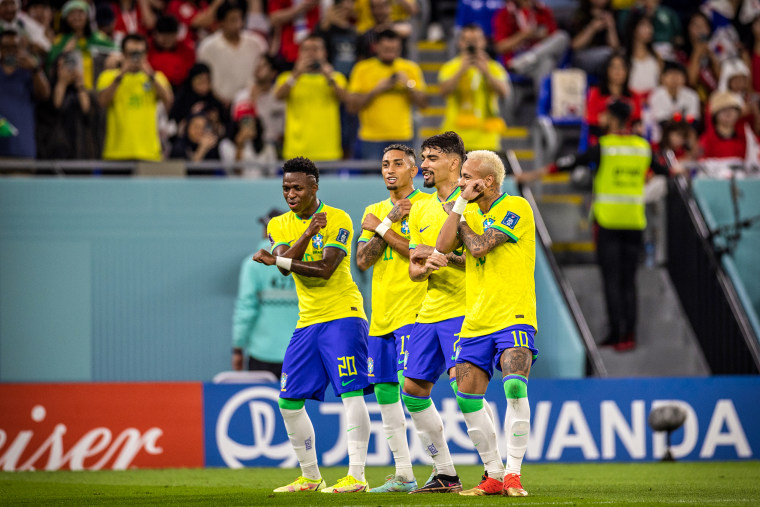 Neymar of Brazil dancing with Lucas Paqueta, Raphinha and Vinicius Junior of Brazil as he celebrates scoring a penalty during the FIFA World Cup Qatar 2022 Round of 16 match between Brazil and South Korea at Stadium 974 on Dec. 5, 2022 in Doha, Qatar.