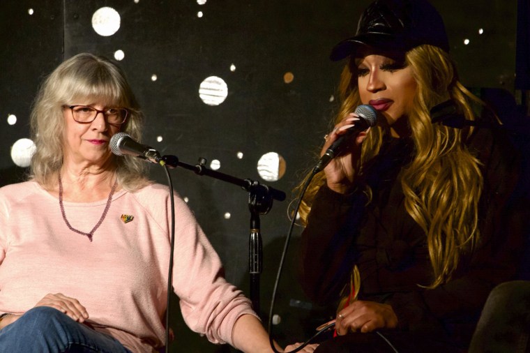 Lauren Mathers,  left, comforts drag queen Naomi Dix during a panel with LGBTQ community leaders 