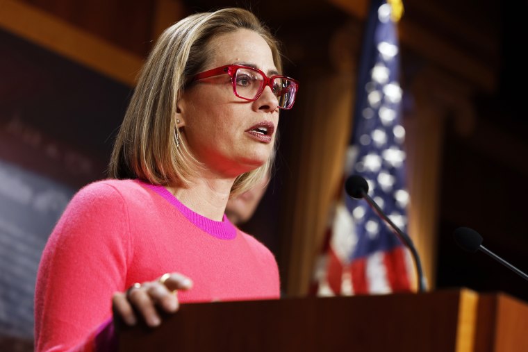 Sen. Kyrtsen Sinema speaks at a news conference in the Capitol 