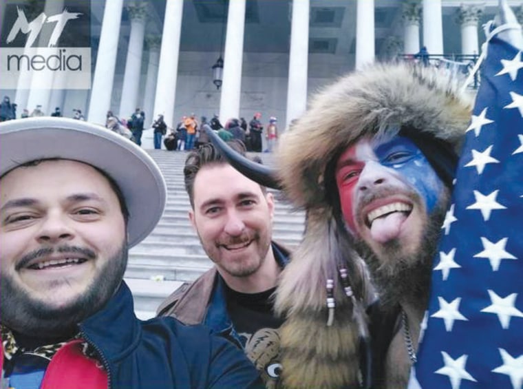 Nicholas DeCarlo, 32, of Fort Worth, Texas, left, and Nicholas Ochs, 36, center, of Honolulu at the Capitol on Jan. 6, 2021.